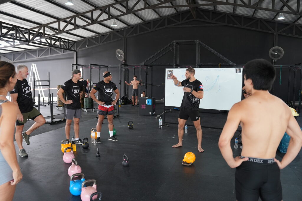 Peter Forneck instructing participants during a KCA Level 2 Performance Certification session inside a gym environment.